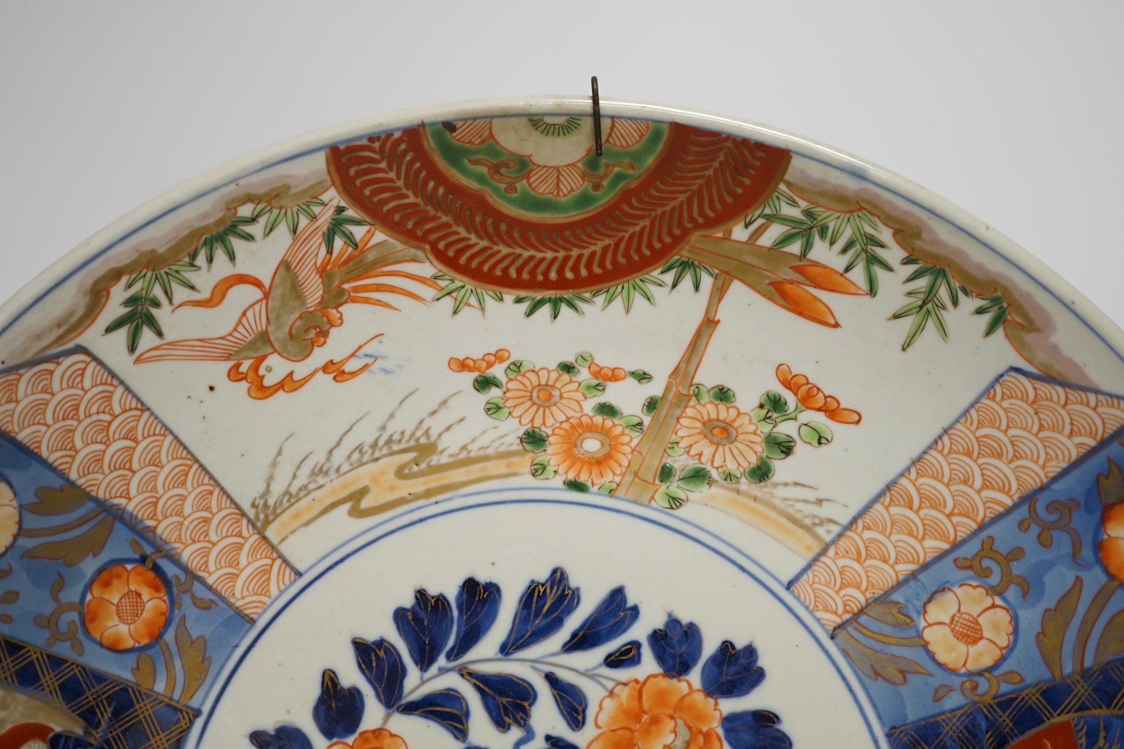 A pair of Japanese cloisonné enamel ‘dragon’ vases and a Japanese Imari dish, 39.5cm diameter (3). Condition - fair to good